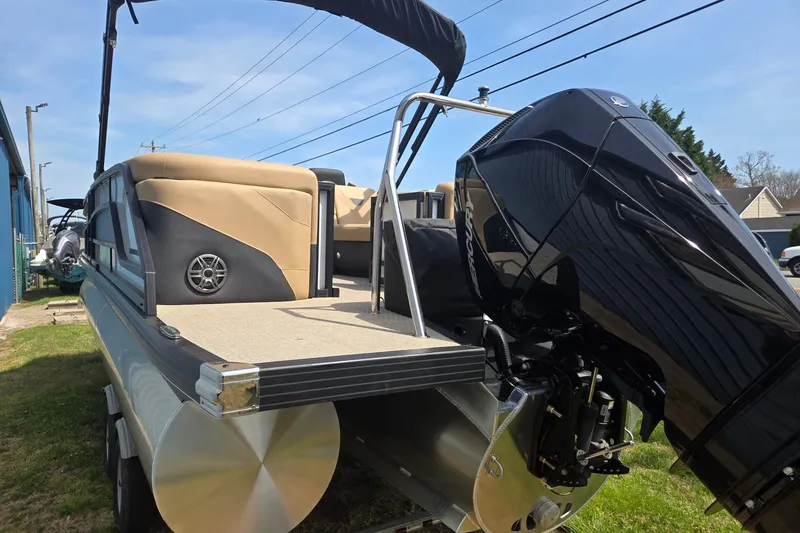 Slide: The Image of 2026 Evotti 523QL pontoon boat with powerful outboard motor, parked outdoors. - 6