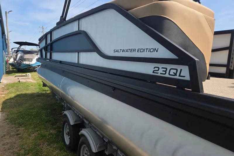 Slide: The Image of 2026 Evotti 523QL Saltwater Edition pontoon boat on trailer, side view. - 7
