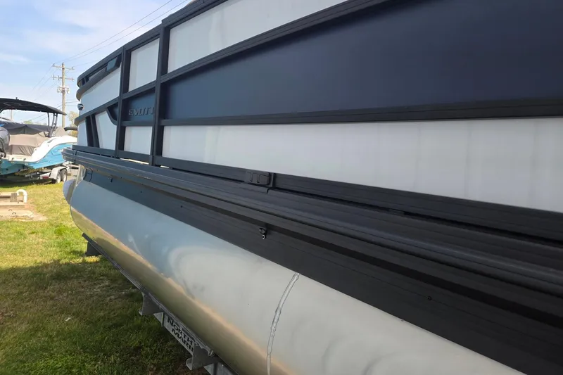 Slide: The Image of 2026 Evotti 523QL pontoon boat side view on grass, showcasing sleek design. - 8