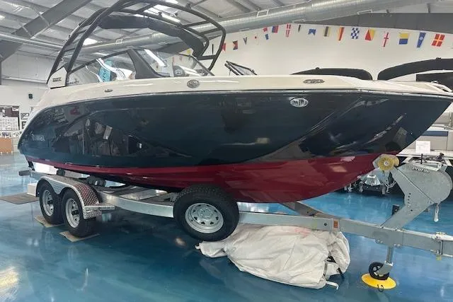 Slide: The Image of 2025 Yamaha Boats 222SE on trailer in showroom, featuring sleek design and vibrant colors. - 10