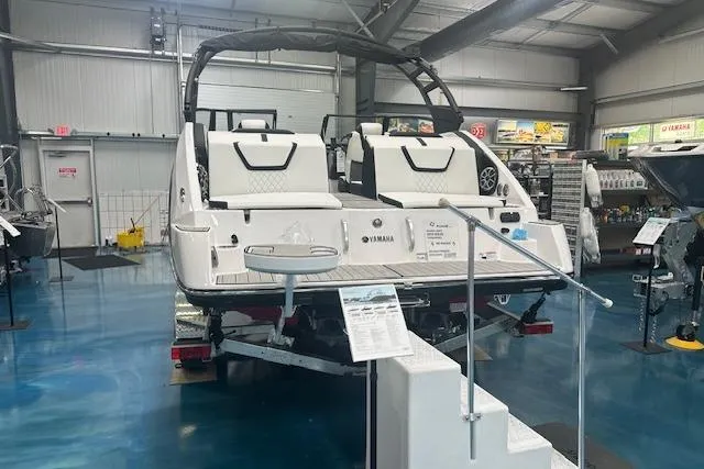 Slide: The Image of 2025 Yamaha Boats 222SE displayed in showroom, featuring sleek design and modern amenities. - 11