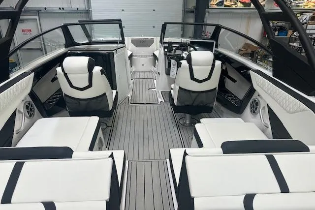 Slide: The Image of 2025 Yamaha Boats 222SE interior with sleek white seating and modern dashboard design. - 12