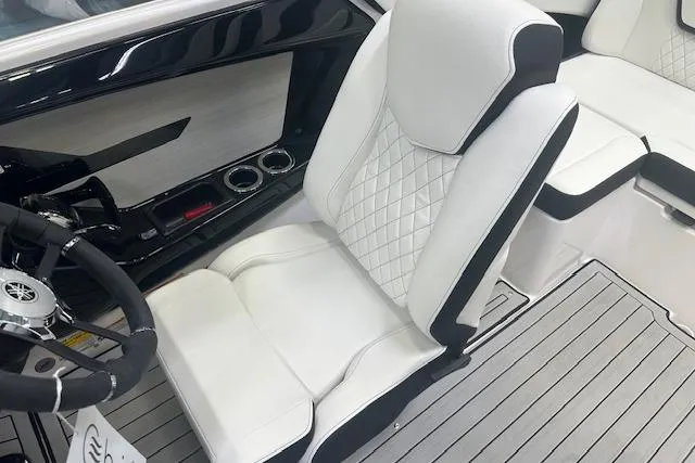 Slide: The Image of 2025 Yamaha Boats 222SE interior with white quilted seats and sleek dashboard design. - 15