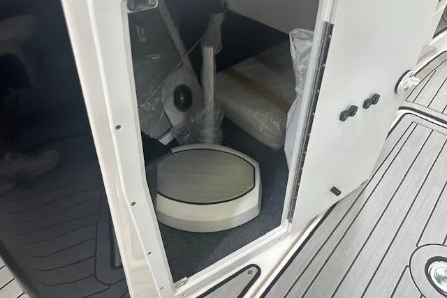 Slide: The Image of 2025 Yamaha Boats 222SE interior storage compartment with modern design and accessories. - 19