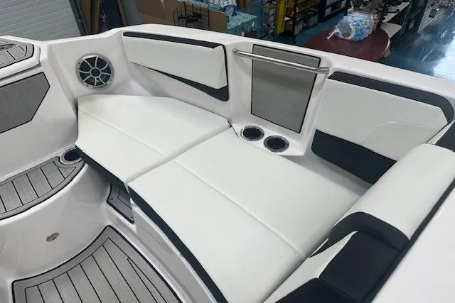 Slide: The Image of 2025 Yamaha Boats 222SE interior with white seating, cup holders, and speaker. - 22