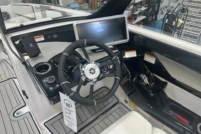 Slide: The Image of Cockpit of 2025 Yamaha Boats 222SE, featuring modern steering wheel and digital display. - 24