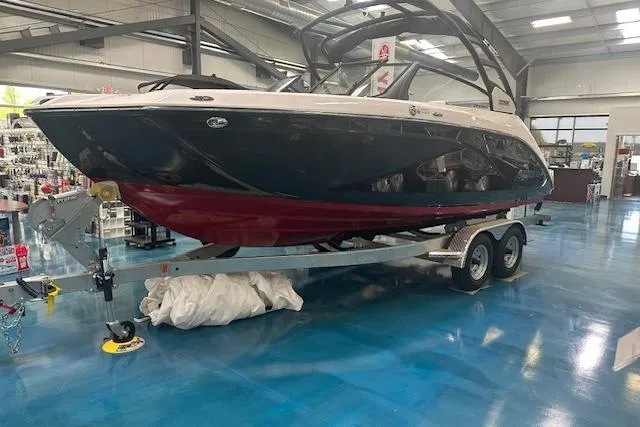 Slide: The Image of 2025 Yamaha Boats 222SE on trailer in showroom, featuring sleek design and modern amenities. - 6