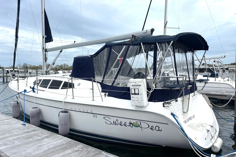 The Image of Sailboat Hunter 39, 2011 model, docked with blue canopy and visible name "Sweet Pea." - 0