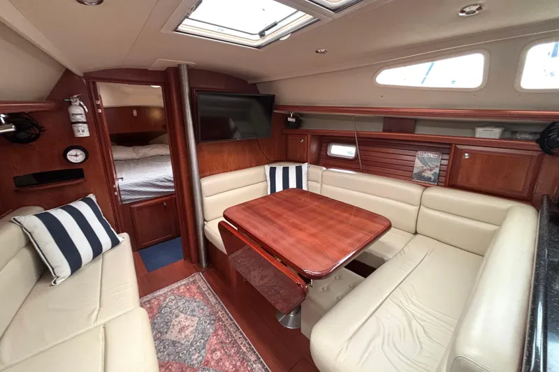 Slide: The Image of Luxurious interior of 2011 Hunter 39 yacht with elegant seating and wooden table. - 10