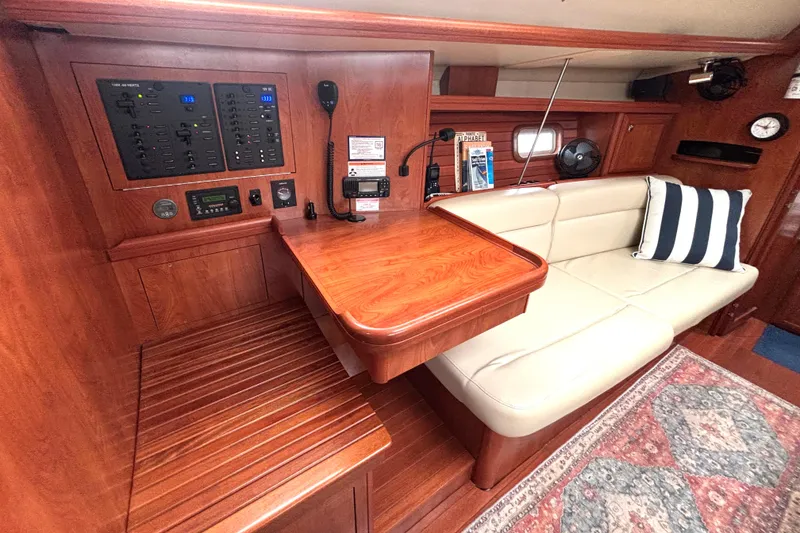 Slide: The Image of Interior of 2011 Hunter 39 sailboat with navigation station and cozy seating area. - 13