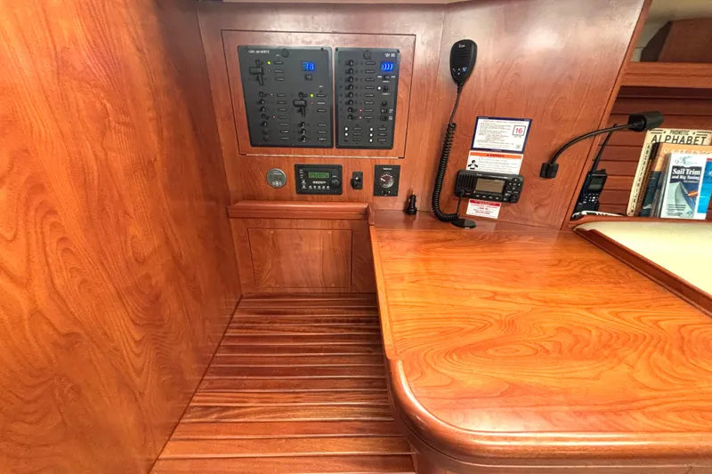 Slide: The Image of Interior of 2011 Hunter 39 sailboat with control panel and wooden finish. - 14