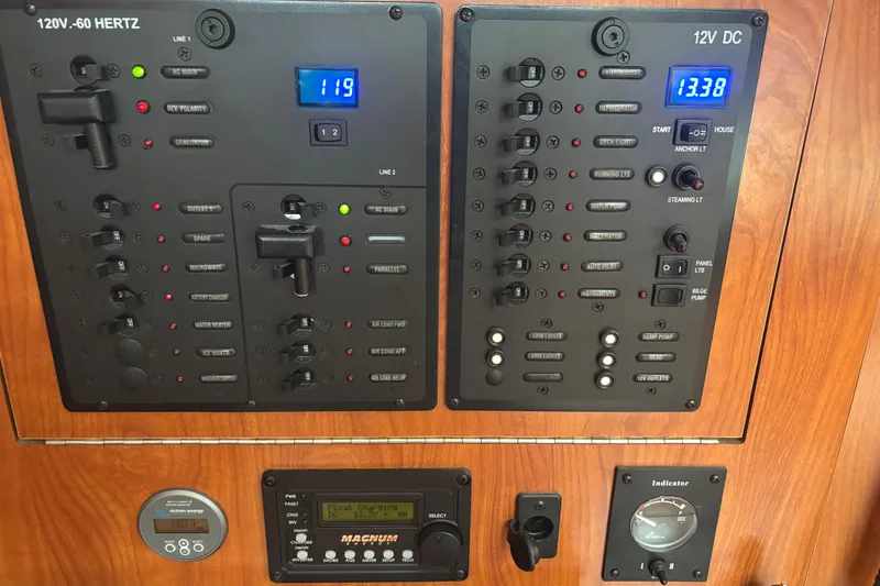 Slide: The Image of Electrical control panel on a 2011 Hunter 39 boat, featuring various switches and indicators. - 15