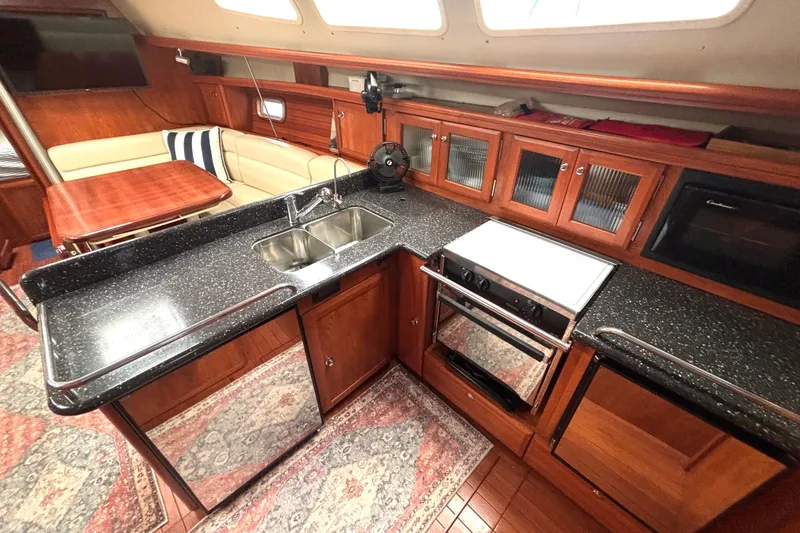Slide: The Image of Luxurious 2011 Hunter 39 yacht interior with modern kitchen and cozy seating area. - 2