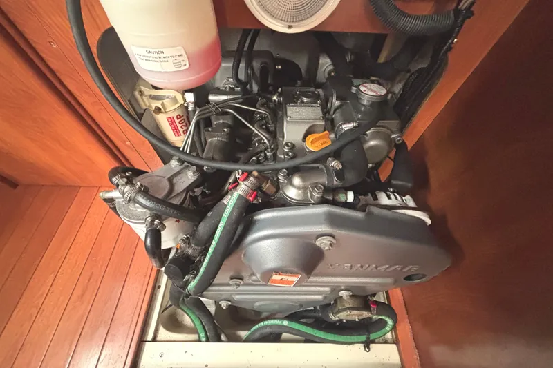 Slide: The Image of Engine compartment of a 2011 Hunter 39 sailboat, featuring a Yanmar engine. - 23