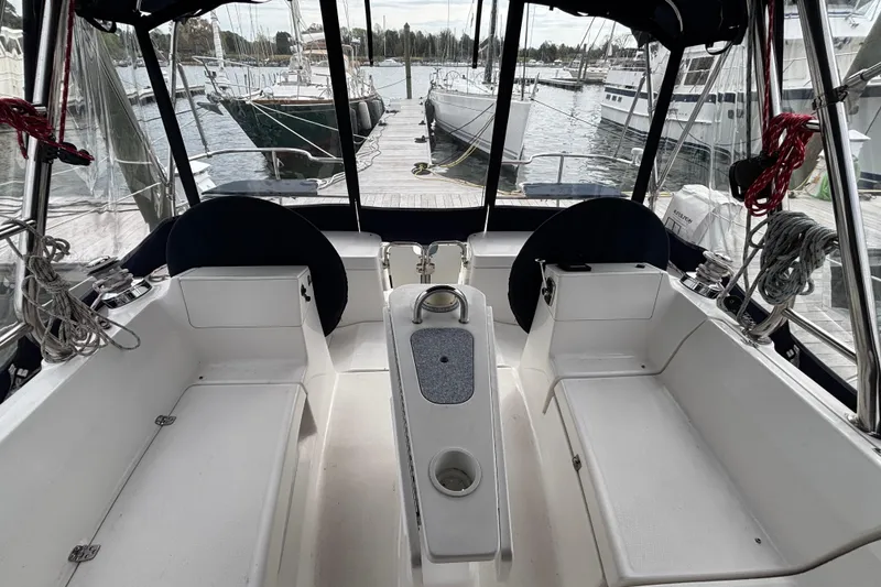 Slide: The Image of Cockpit of 2011 Hunter 39 sailboat docked at marina, featuring seating and steering area. - 28