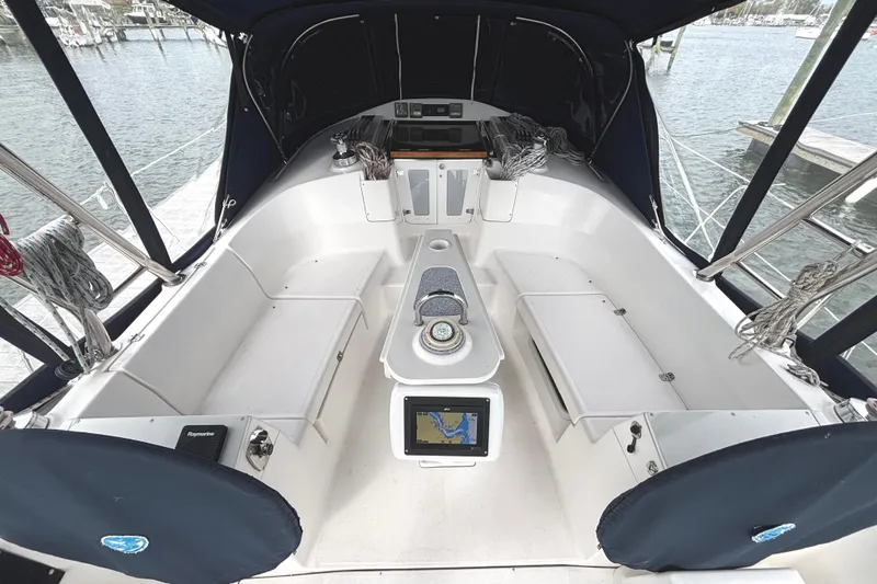 Slide: The Image of 2011 Hunter 39 sailboat cockpit with navigation equipment and seating, docked at marina. - 29