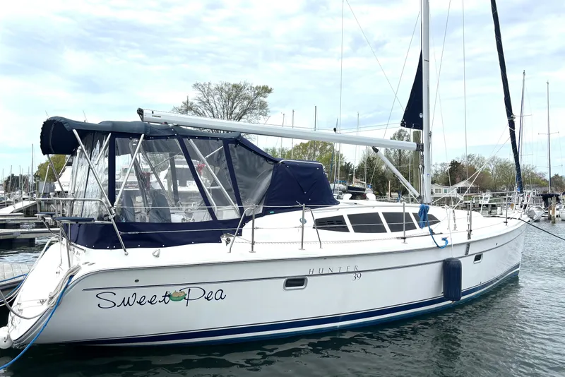 Slide: The Image of 2011 Hunter 39 sailboat named "Sweet Pea" docked at a marina. - 32