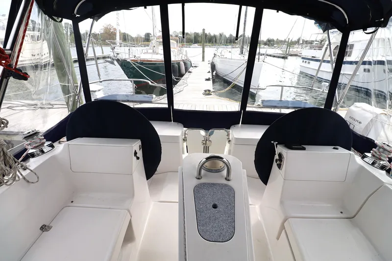 Slide: The Image of Cockpit view of a 2011 Hunter 39 sailboat docked at a marina. - 39