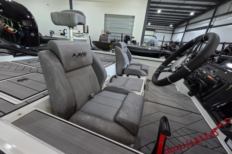 Slide: The Image of Interior of 2026 Avid 20 Vertex boat with modern seating and steering wheel. - 11