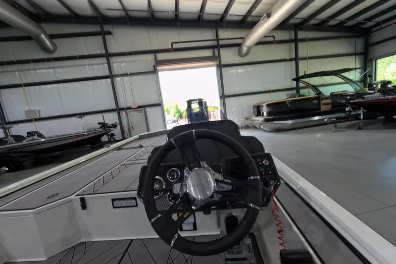 Slide: The Image of Interior view of a 2026 Avid 20 Vertex boat in a spacious showroom. - 12