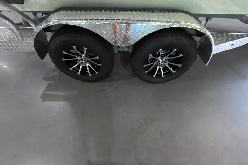 Slide: The Image of 2026 Avid 20 Vertex trailer with dual black alloy wheels and diamond plate fenders. - 13