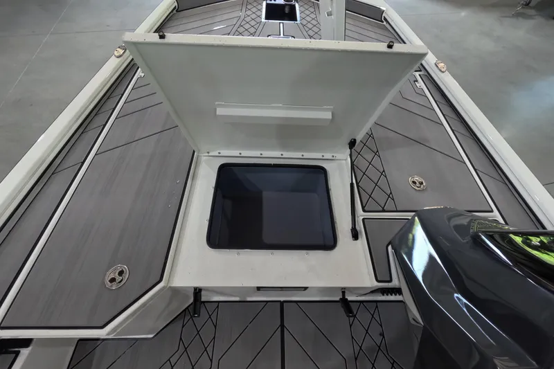 Slide: The Image of 2026 Avid 20 Vertex boat deck with open storage compartment and sleek design. - 16