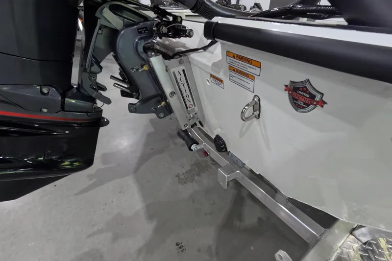 Slide: The Image of 2026 Avid 20 Vertex boat motor and transom with warning labels and lifetime warranty badge. - 3