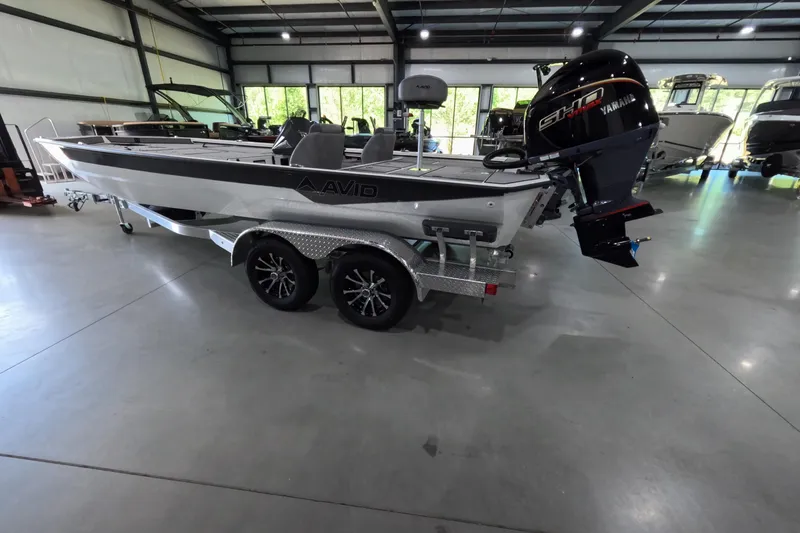 Slide: The Image of 2026 Avid 20 Vertex boat with Yamaha engine in showroom setting. - 4