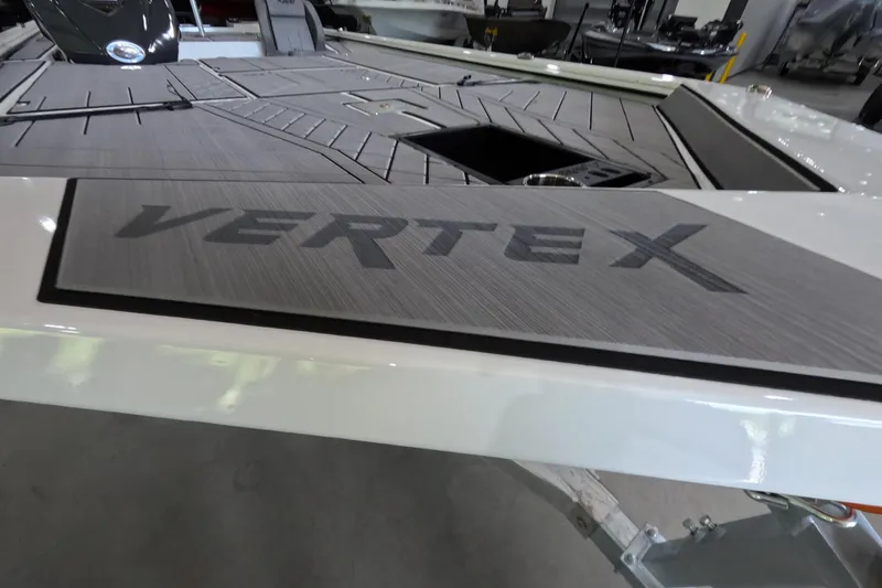 Slide: The Image of 2026 Avid 20 Vertex boat deck with "Vertex" branding in a showroom setting. - 9