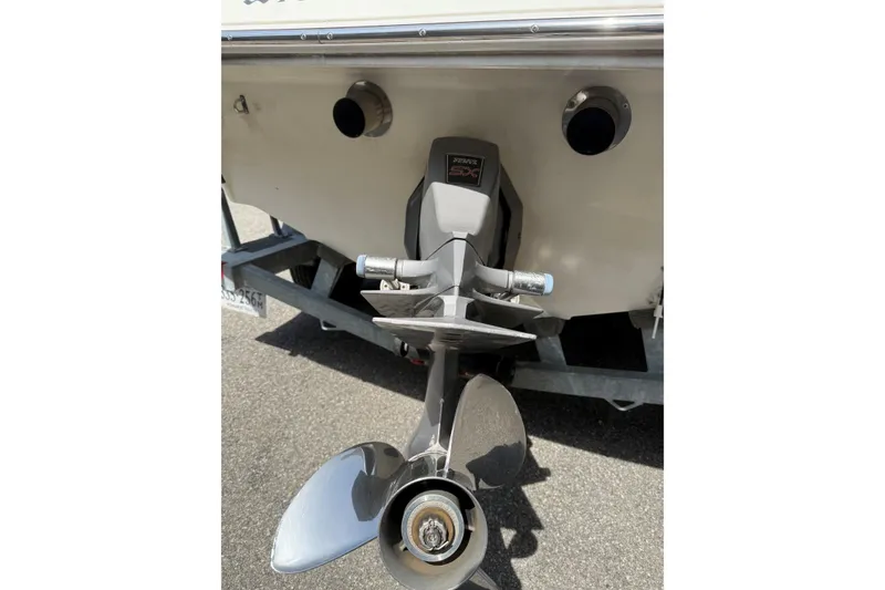 Slide: The Image of Rear view of a 2003 Four Winns 210 Horizon boat with visible propeller and exhaust. - 4