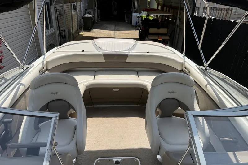 Slide: The Image of 2003 Four Winns 210 Horizon boat interior with beige seating and open cockpit. - 6