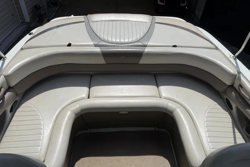 Slide: The Image of 2003 Four Winns 210 Horizon boat interior with beige leather seating and carpeted floor. - 7