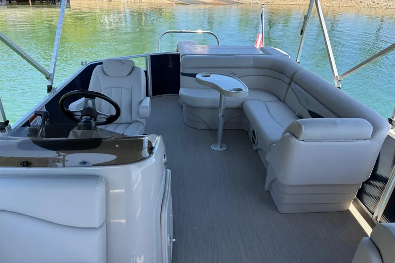 Slide: The Image of 2017 Bennington 21 SLX pontoon boat interior with plush seating and steering console. - 10