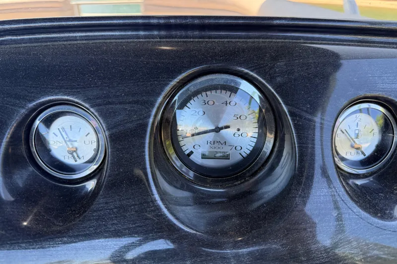 Slide: The Image of Dashboard gauges of a 2017 Bennington 21 SLX boat, showing RPM, trim, and fuel levels. - 17
