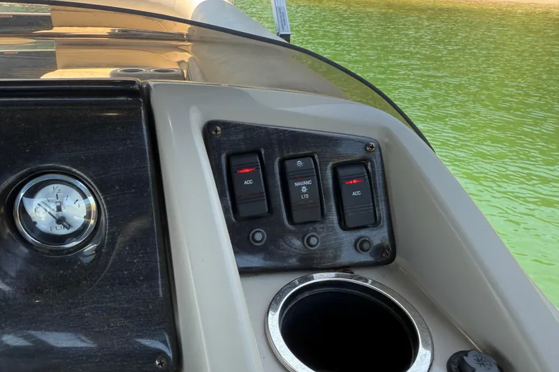 Slide: The Image of Control panel of a 2017 Bennington 21 SLX boat with switches and fuel gauge. - 19