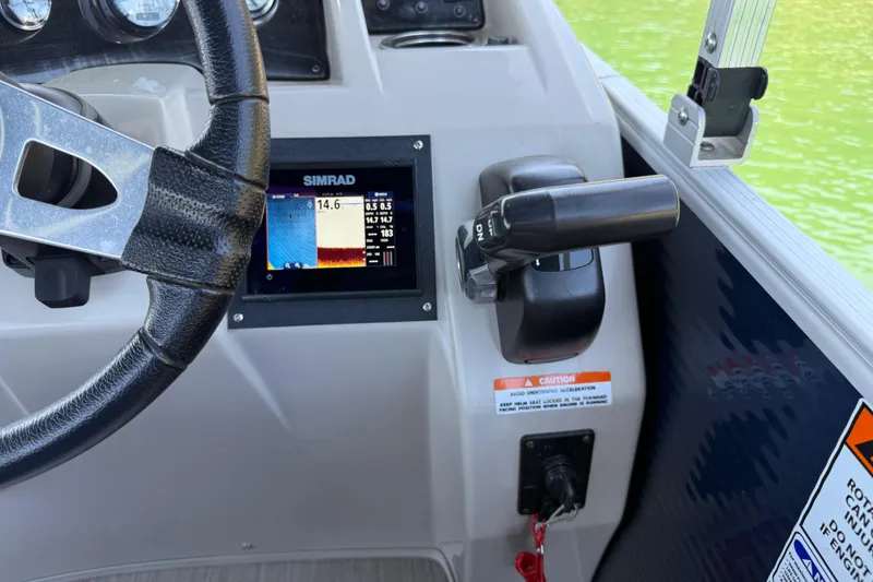 Slide: The Image of Steering wheel and control panel of 2017 Bennington 21 SLX boat with Simrad display. - 24