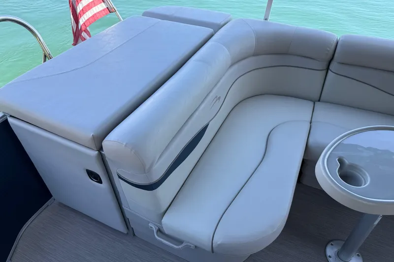 Slide: The Image of Luxurious seating on a 2017 Bennington 21 SLX pontoon boat with cup holder and American flag. - 25
