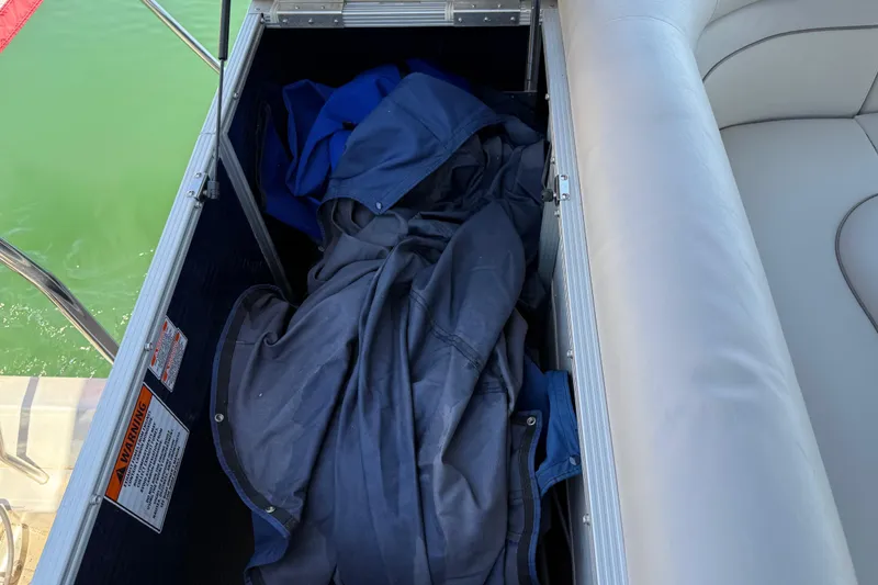Slide: The Image of Storage compartment on a 2017 Bennington 21 SLX boat with jackets inside. - 26