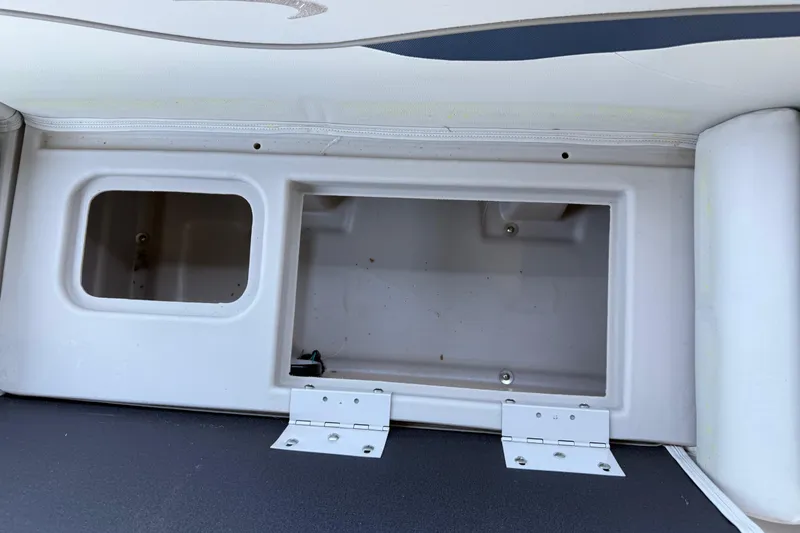 Slide: The Image of Storage compartment on a 2017 Bennington 21 SLX boat, featuring open hatch and interior view. - 28