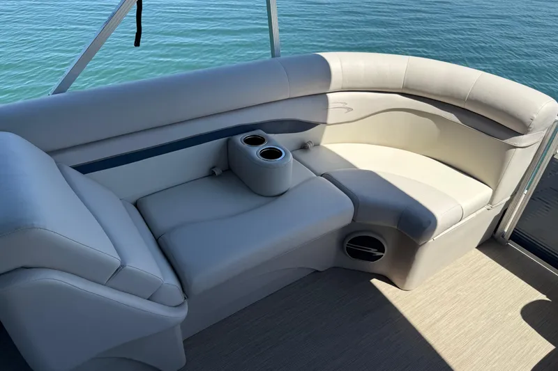 Slide: The Image of Luxurious seating on a 2017 Bennington 21 SLX pontoon boat with cup holders, overlooking water. - 32
