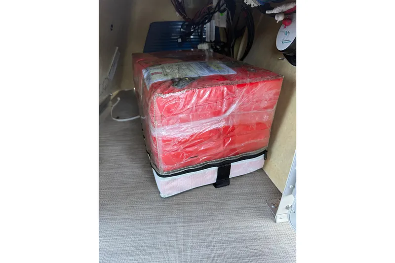 Slide: The Image of Red life jackets stored under the seat of a 2017 Bennington 21 SLX boat. - 39