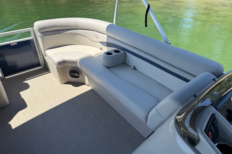 Slide: The Image of 2017 Bennington 21 SLX pontoon boat interior with plush seating and cup holders. - 8