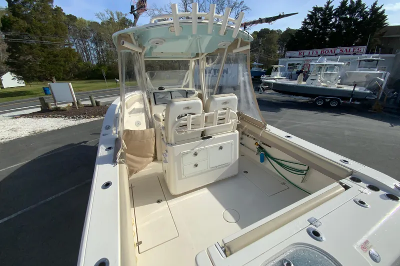 Slide: The Image of 2017 Cobia 277 Center Console boat at dealership, showcasing spacious deck and seating. - 10