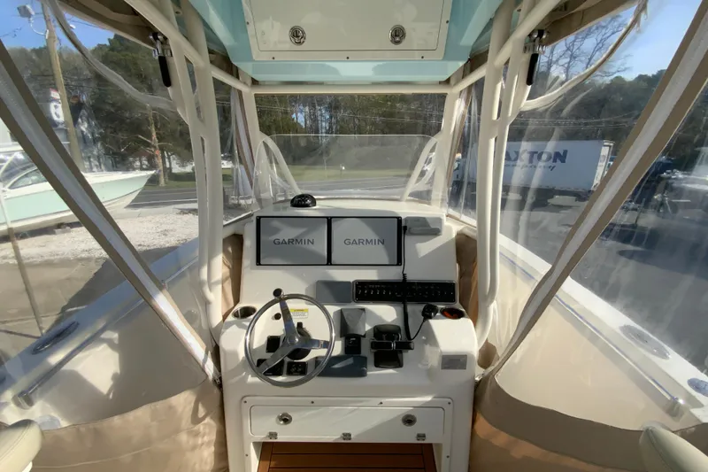 Slide: The Image of 2017 Cobia 277 Center Console boat cockpit with Garmin navigation displays. - 11