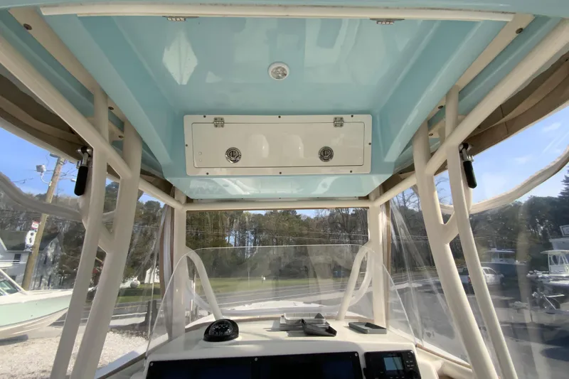 Slide: The Image of 2017 Cobia 277 Center Console boat interior with clear canopy and control panel. - 18