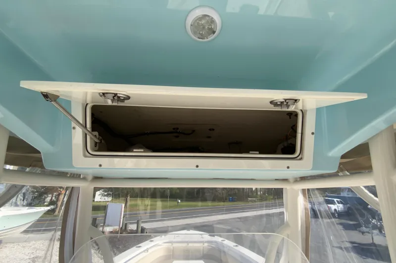 Slide: The Image of 2017 Cobia 277 Center Console boat with open overhead storage compartment. - 19
