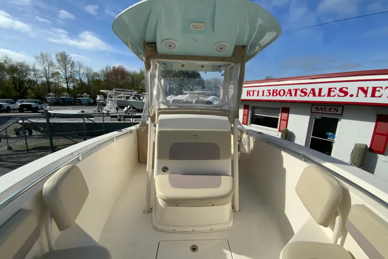 Slide: The Image of 2017 Cobia 277 Center Console boat at dealership, showcasing spacious seating and helm. - 25