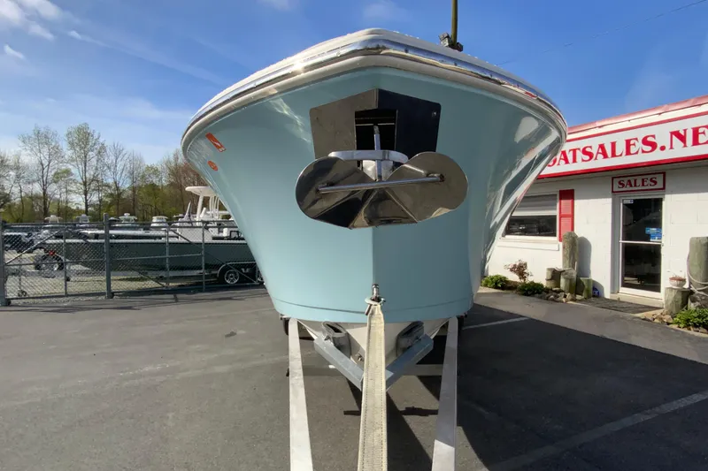 Slide: The Image of 2017 Cobia 277 Center Console boat on trailer at dealership, sunny day. - 4
