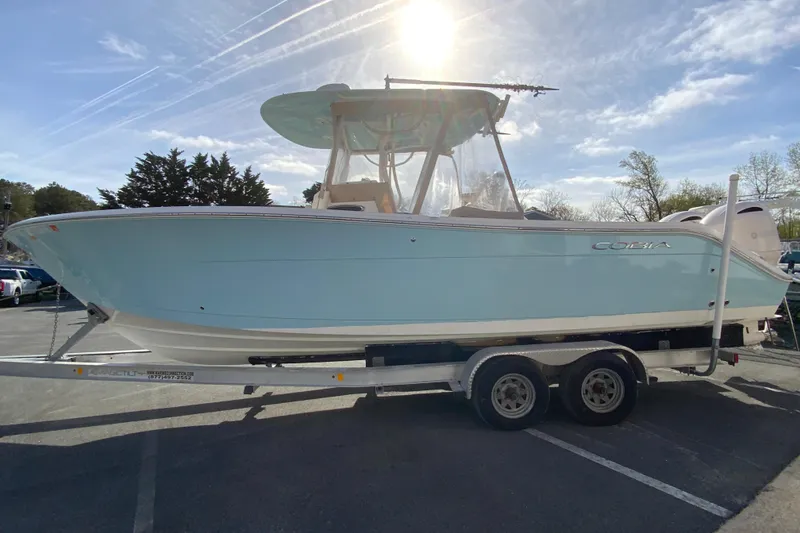Slide: The Image of 2017 Cobia 277 Center Console boat on trailer under sunny sky. - 6