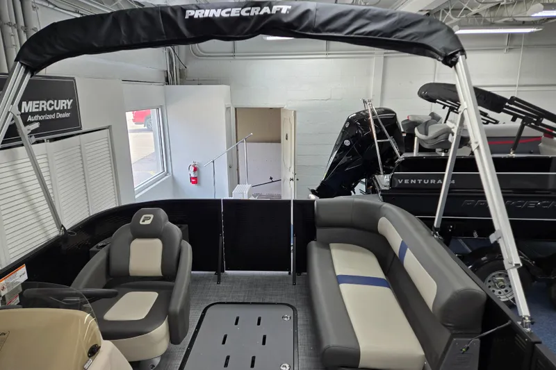 Slide: The Image of 2026 Princecraft Brio 17 Electric boat interior with seating and canopy in showroom. - 11